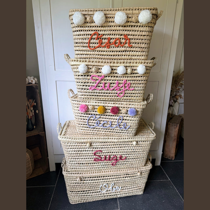 Detail van punnik naam op een handgemaakte mand van 60 cm uit palmblad.
